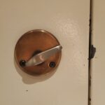 Bronze Deadbolt on a white door