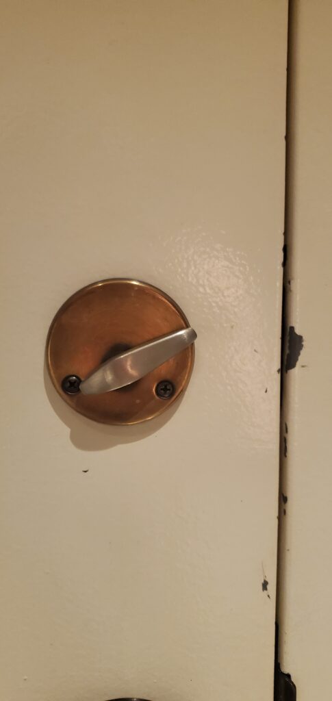 Bronze Deadbolt on a white door