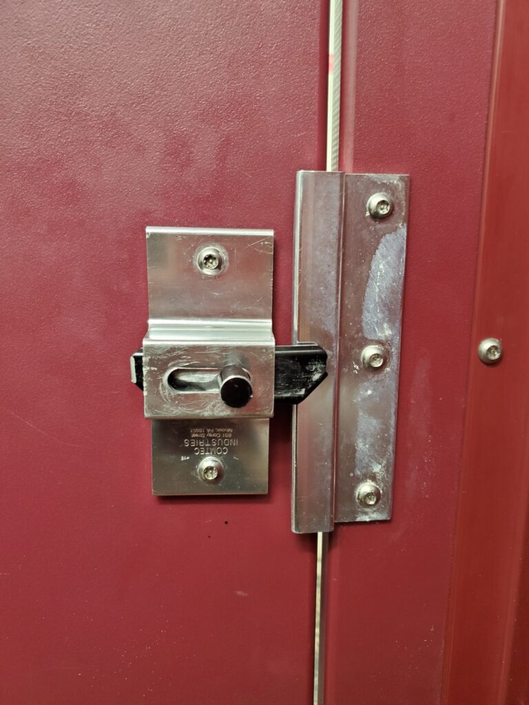 Silver and Black Slide Bolt Latch on Red Stall