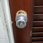 Silver Knobset Twist Lock on Wood in a Tiny Bathroom - the lock and wood wear