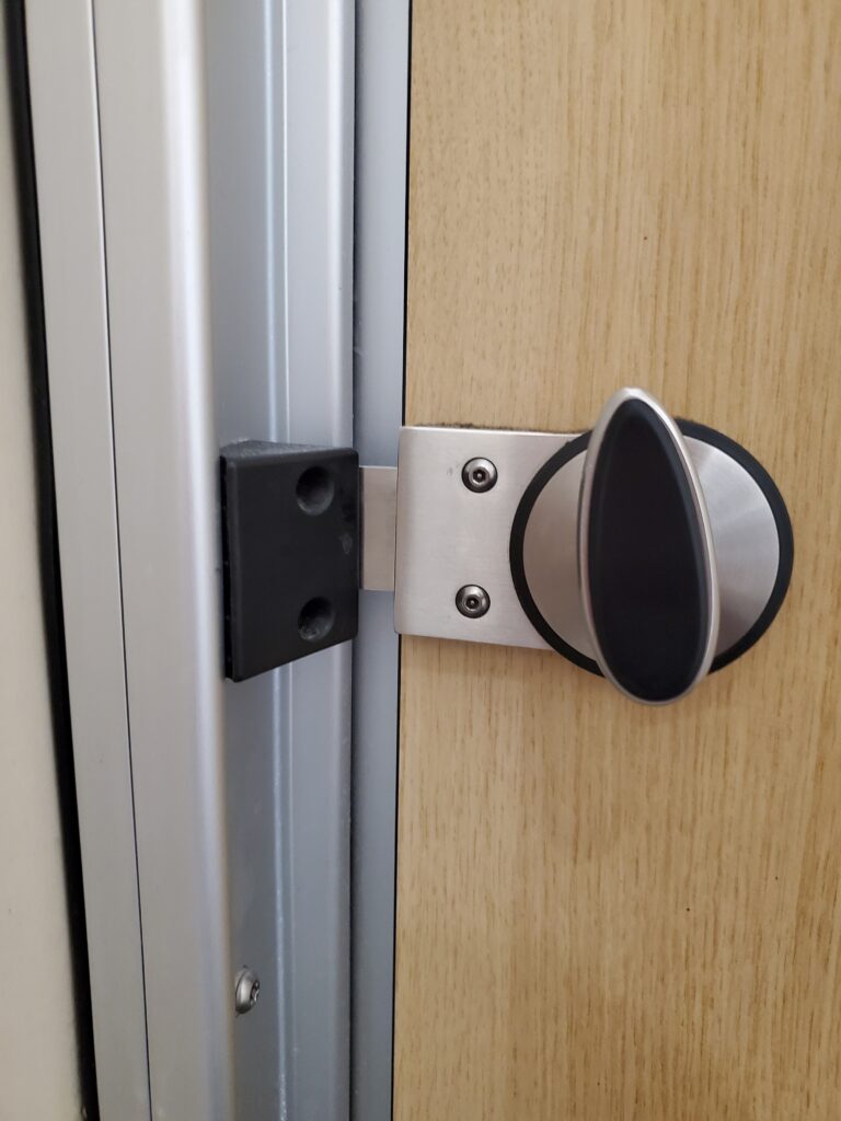 Twisting Flat Bolt Latch on Wood & Metal - Heathrow Airport in London