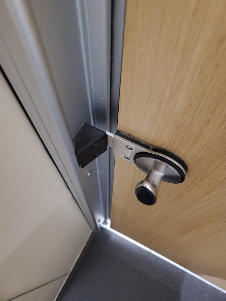 Twisting Flat Bolt Latch on Wood & Metal - Heathrow Airport in London