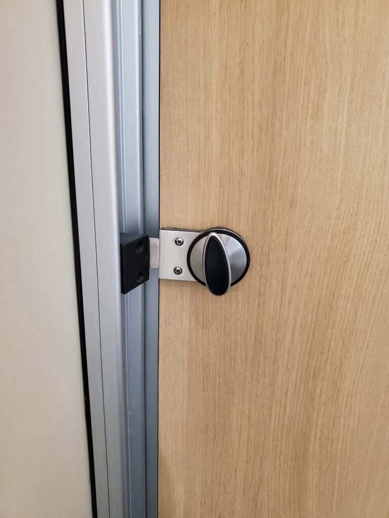 Twisting Flat Bolt Latch on Wood & Metal - Heathrow Airport in London